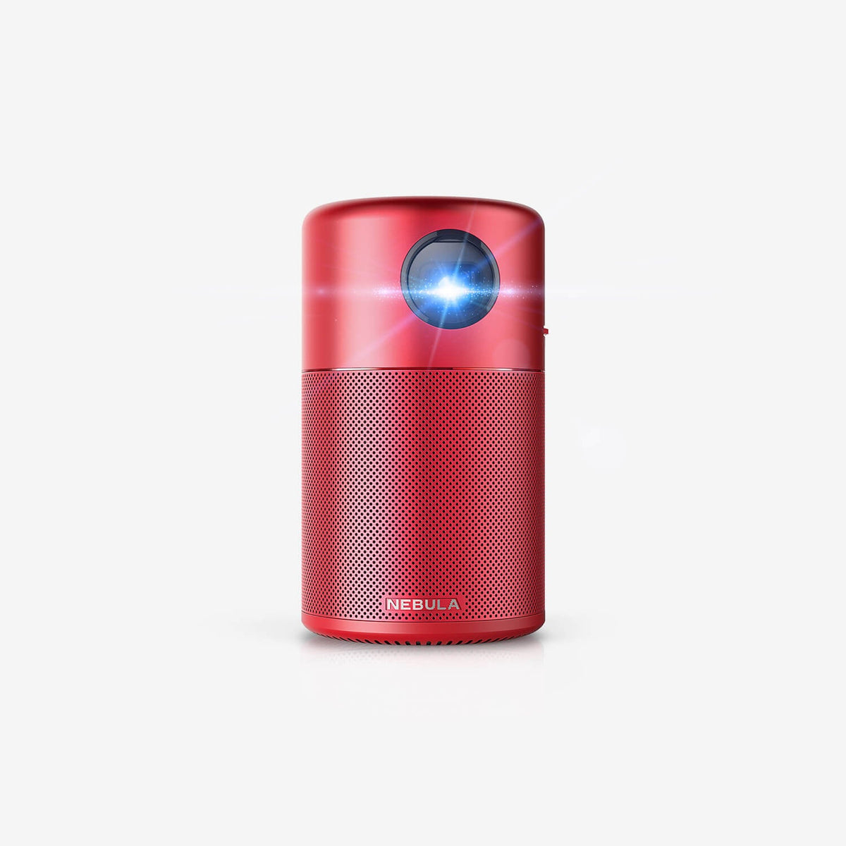 A red Nebula Capsule portable projector sits in a white room while projecting a blue light toward the camera.